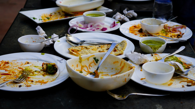 Restaurant table full of dirty plates