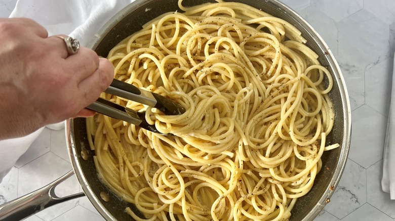 serving pasta with tongs