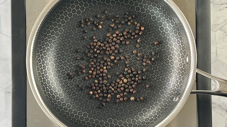 peppercorns toasting in pan