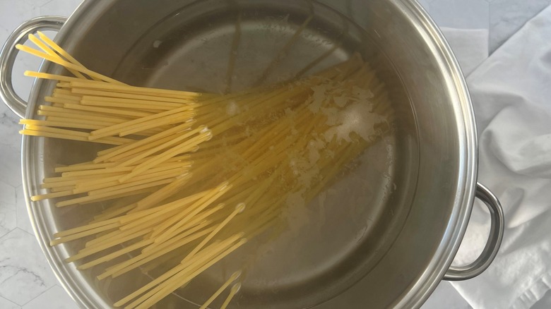 uncooked pasta added to water