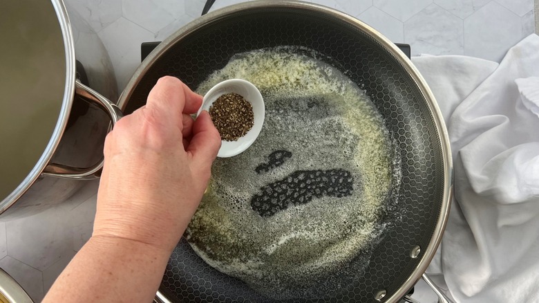 adding pepper to melted butter