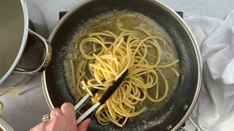 adding pasta to butter sauce