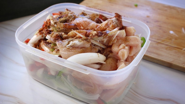 container of marinating chicken and vegetables