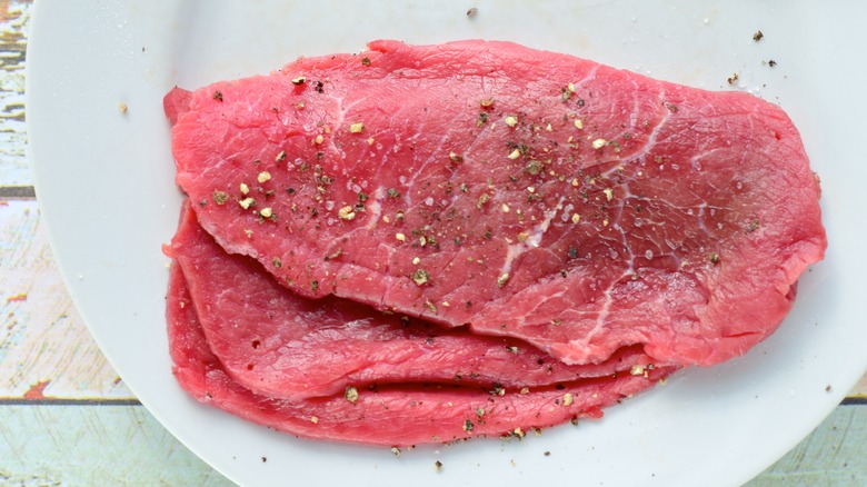 seasoned minute steak on plate