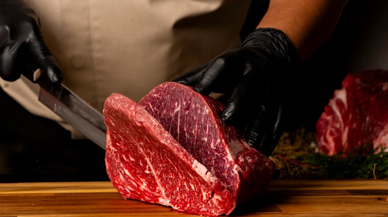 butcher cutting steak