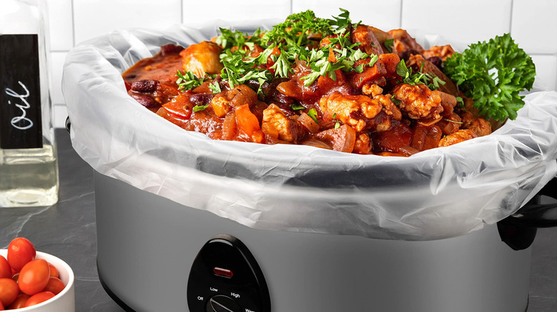 Chicken and vegetables in a slower cooker with a plastic liner