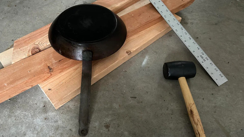 Warped pan with a hammer