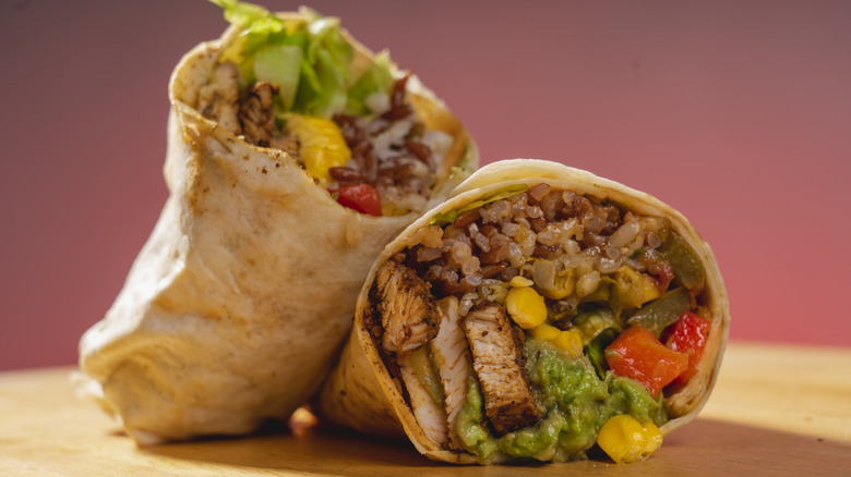 Loaded burrito against red background