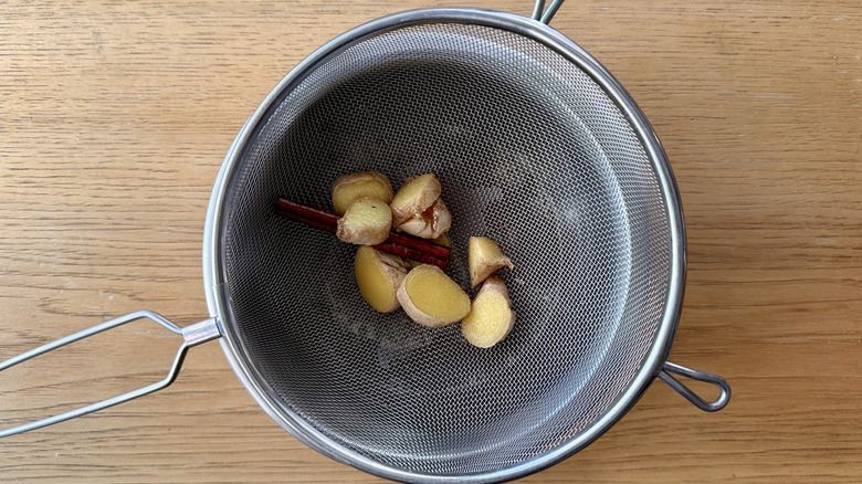 Pieces of ginger root in strainer