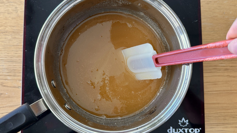 Stirring sugar into ginger candy mixture