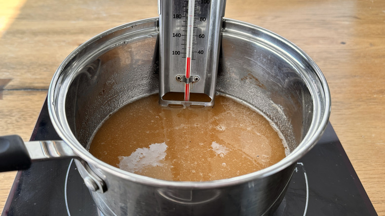 Ginger candy mixture and thermometer in pot