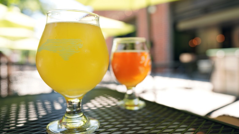 Gose beers with yellow and orange hues in glasses on a patio table