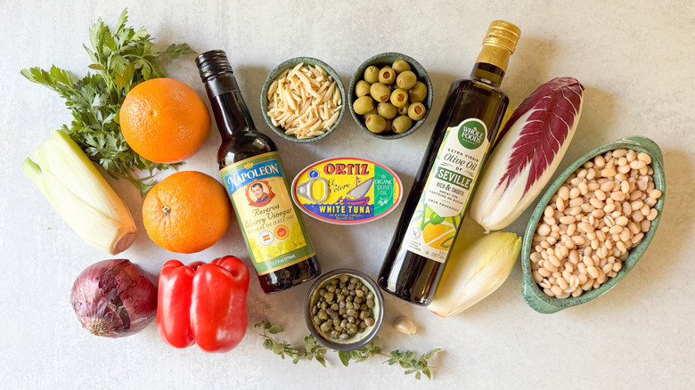 Spanish-inspired tuna salad with white beans and oranges ingredients on countertop