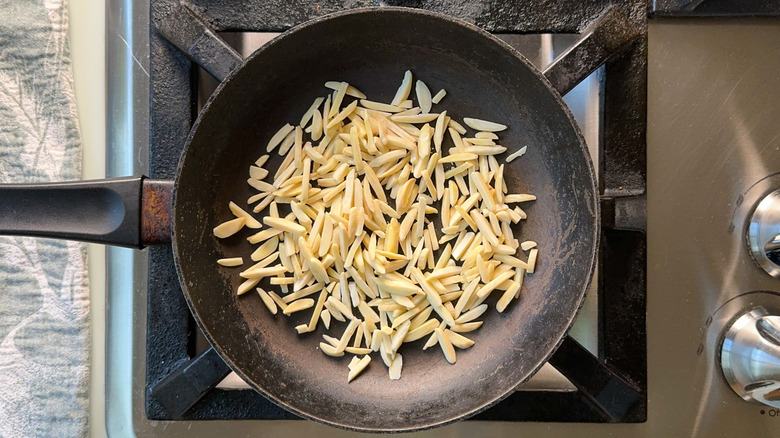 Slivered almonds in skillet on stovetop