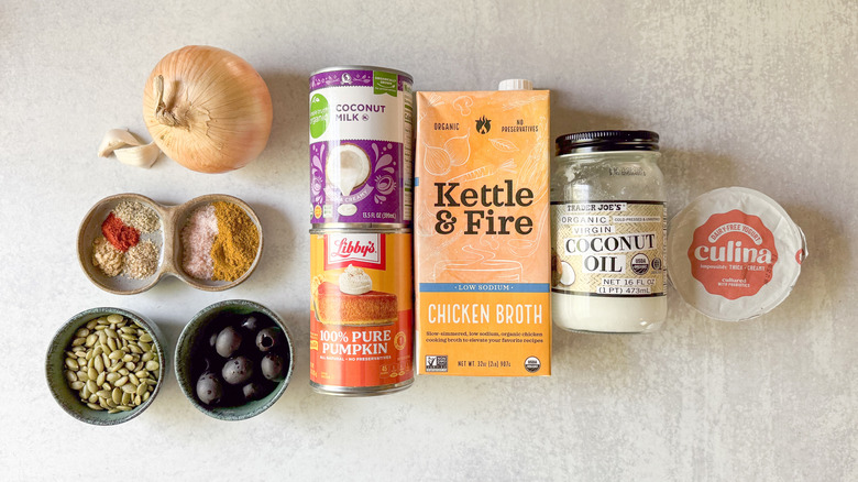 Spooky pumpkin curry Halloween soup ingredients on countertop