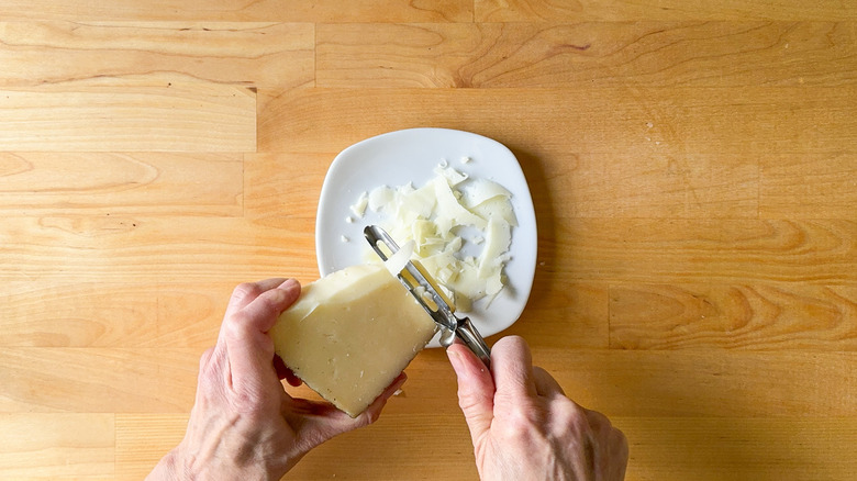 Shaving manchego cheese with vegetable peeler