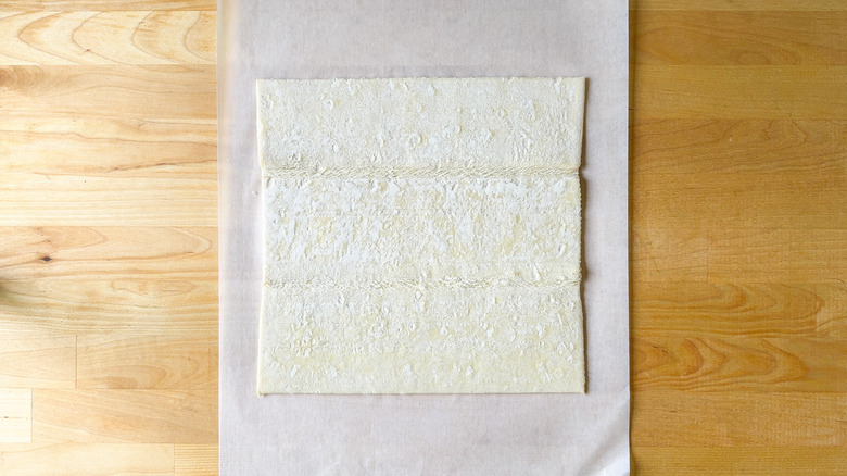 Puff pastry sheet on parchment paper 