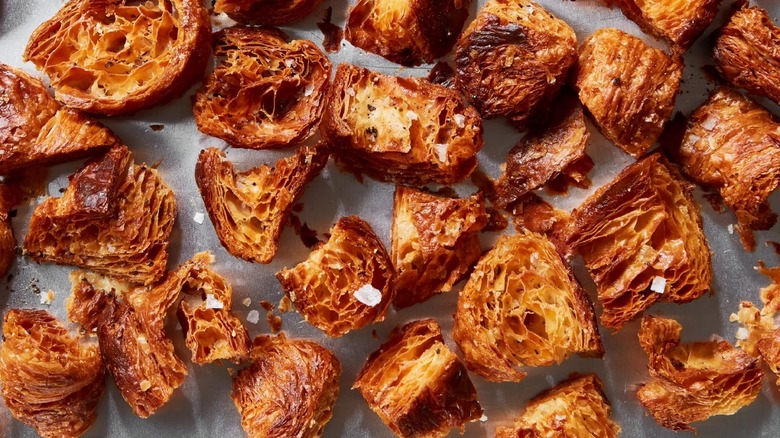 Salted, toasted croissant croutons on parchment