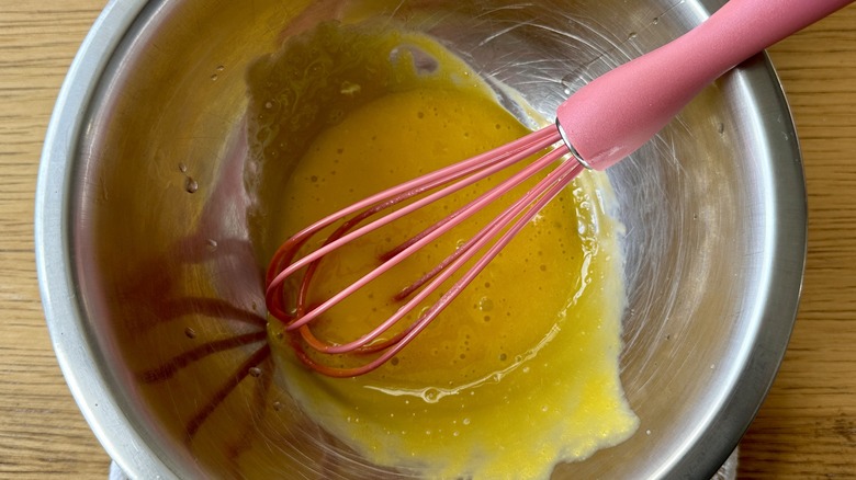 Whisking egg yolks in bowl