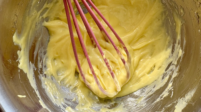 Adding lemon and garlic to aioli