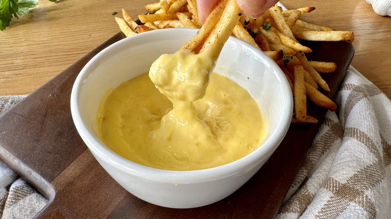 French fries dipping into aioli