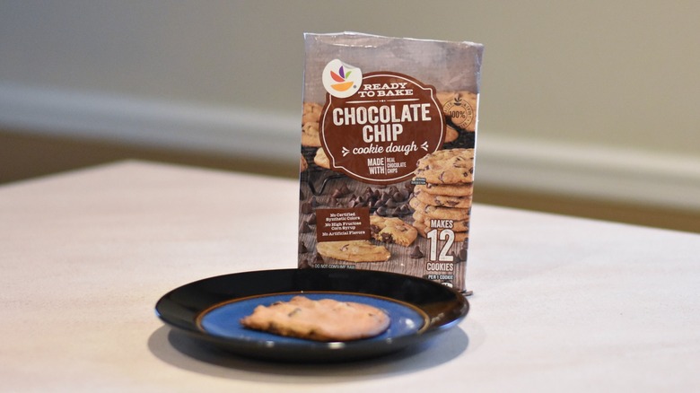 A package of Giant chocolate chip cookie dough with a baked cookie on a blue and black plate