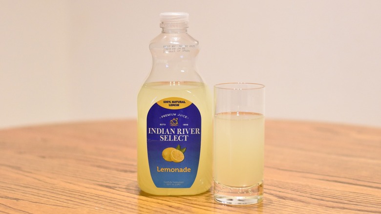 A jug of Indian River Select lemonade next to a glass of lemonade