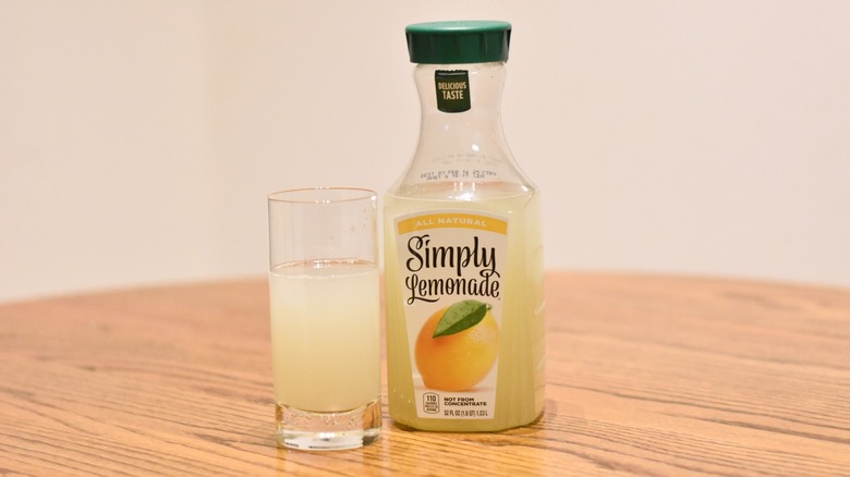 A jug of Simply Lemonade next to a glass of lemonade