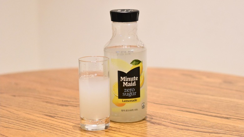 A bottle of Minute Maid zero-sugar lemonade next to a glass of lemonade