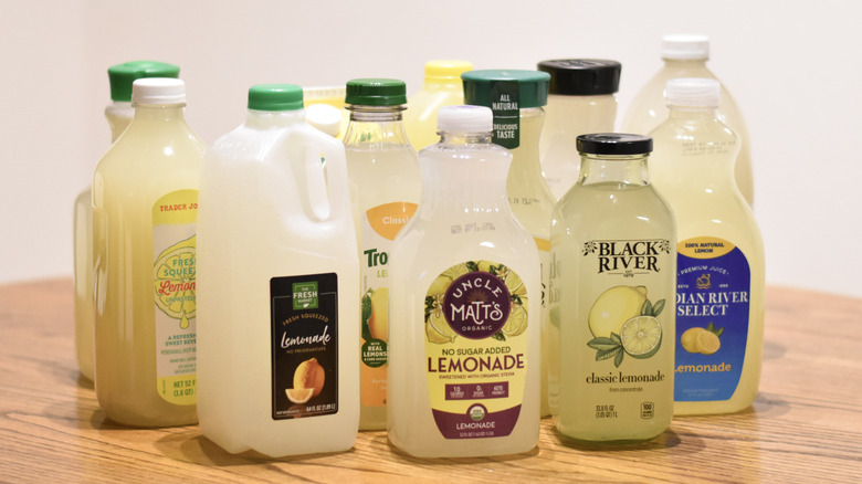 A collection of lemonade bottles on a wooden table