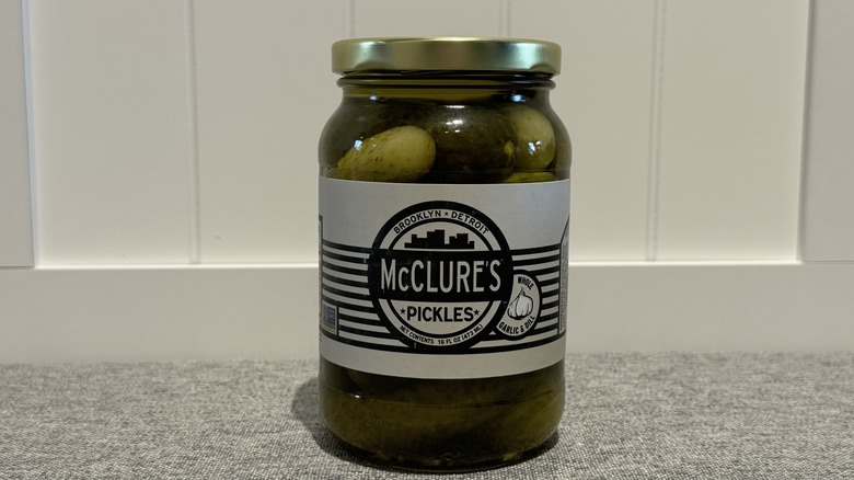 A jar of McClure's Whole Garlic & Dill Pickles