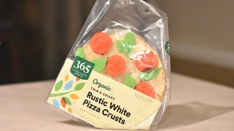 A package of 365 organic thin and crispy rustic white pizza crusts