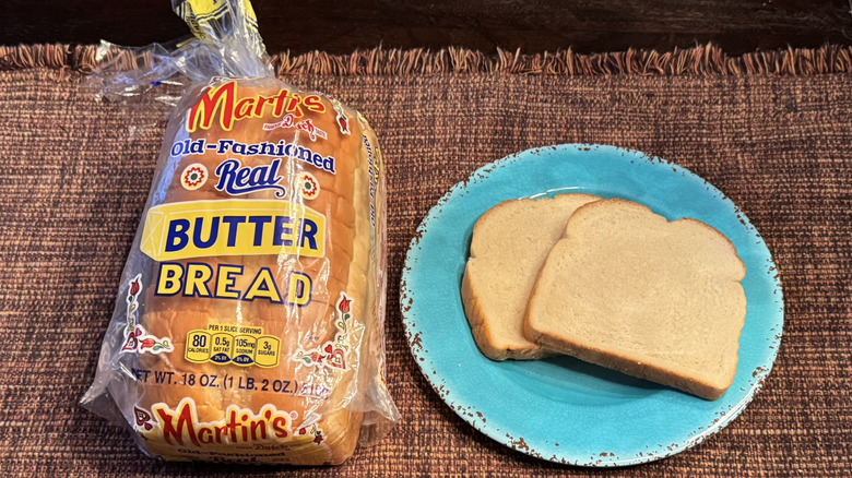 A loaf of Martin's butter bread and two slices on a blue plate