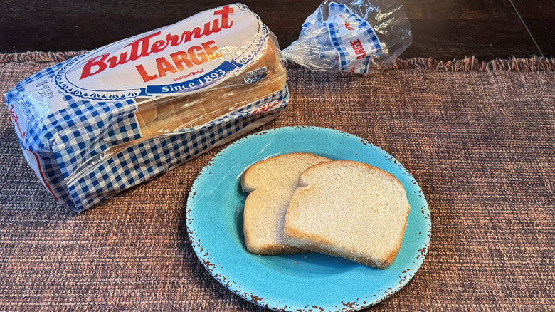 Loaf of Butternut white bread and two slices on a blue plate