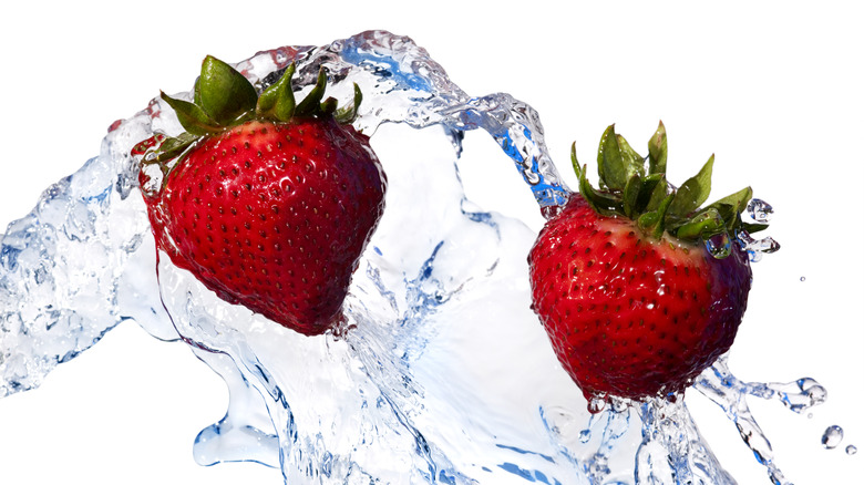 Strawberries swimming in water