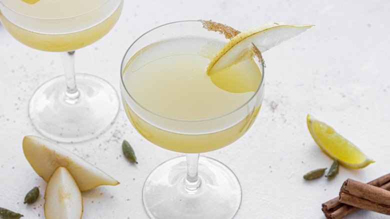 Pear martini in a glass garnished with pear slice and brown sugar rim