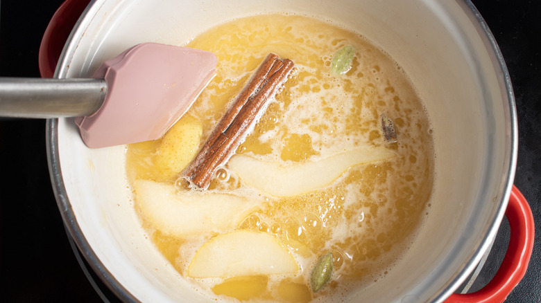 Stirring pear and cinnamon syrup