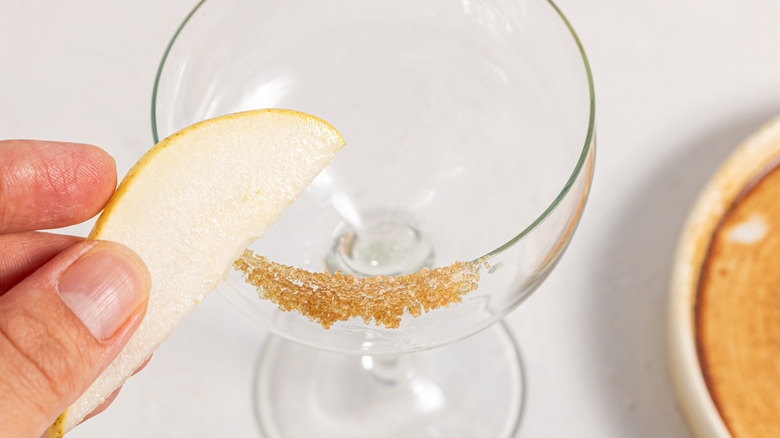 Placing pear slice to a sugar rim glass