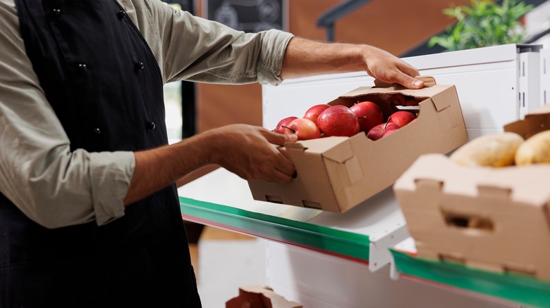 Grocer moving produce box