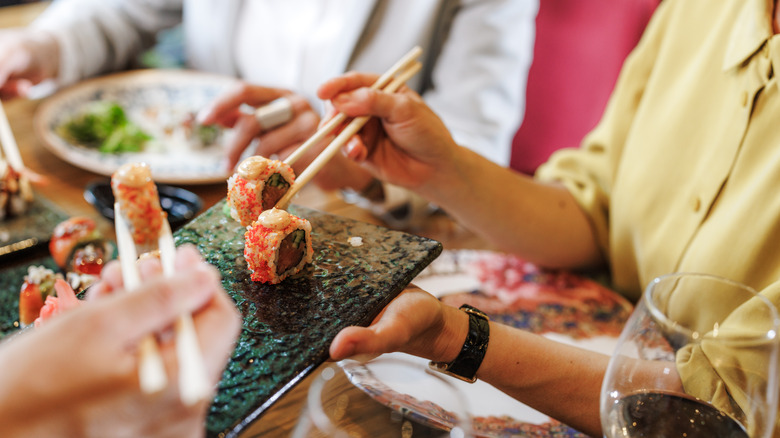 People passing sushi around