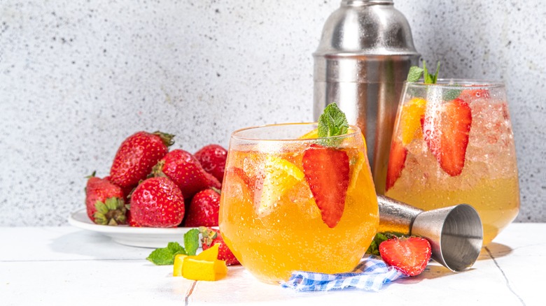 sparking wine sangria with strawberries, orange, and mint leaves