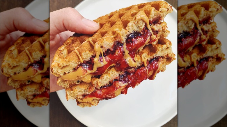 Holding a waffle PB&J sandwich