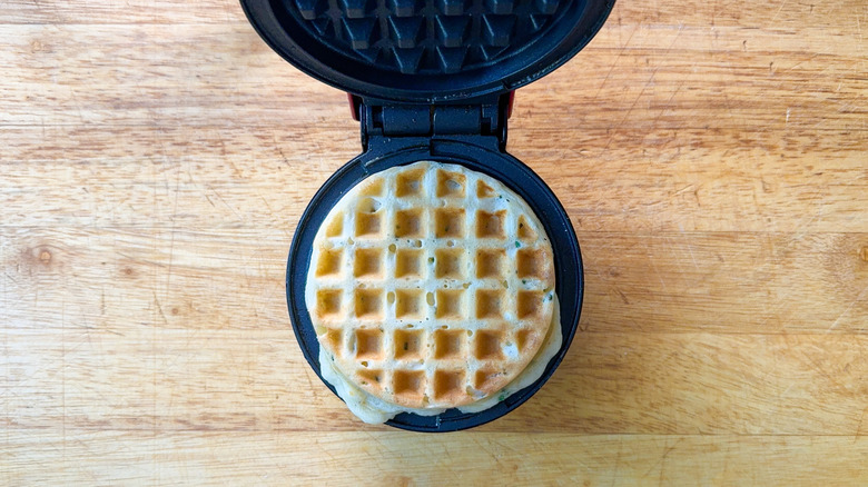 Savory waffles on parchment-lined baking sheet