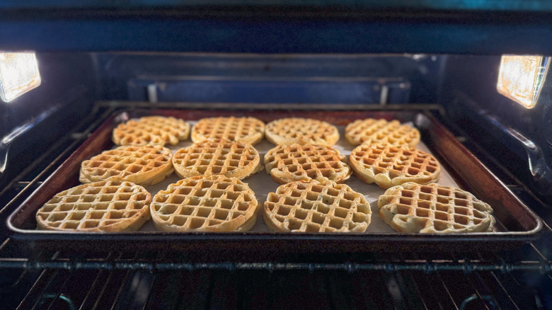 Waffles on parchment-lined baking sheet in oven