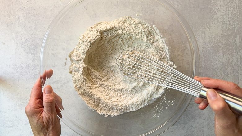 Whisking together waffles dry ingredients in glass bowl