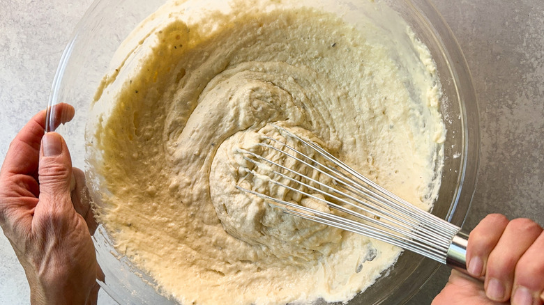 Whisking waffle batter in large glass bowl