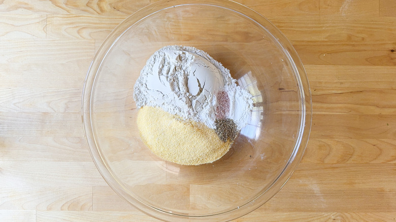 Cornbread dry ingredients in glass bowl on countertop