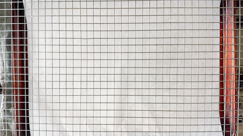 Baking sheet lined with parchment paper and baking rack