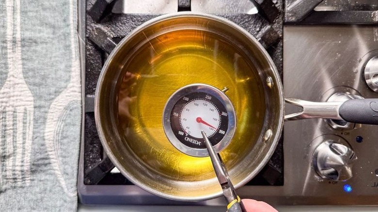 Avocado oil in pan heated to 350 F with thermometer