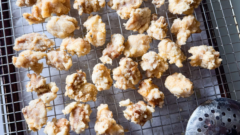 Korean fried popcorn chicken on rack on baking sheet
